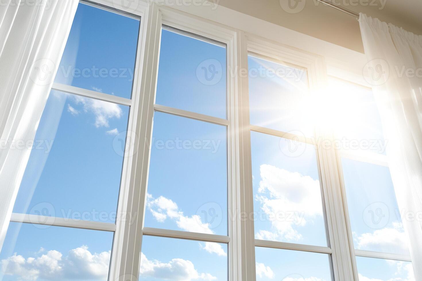 A window with white curtains and a sunny sky photo