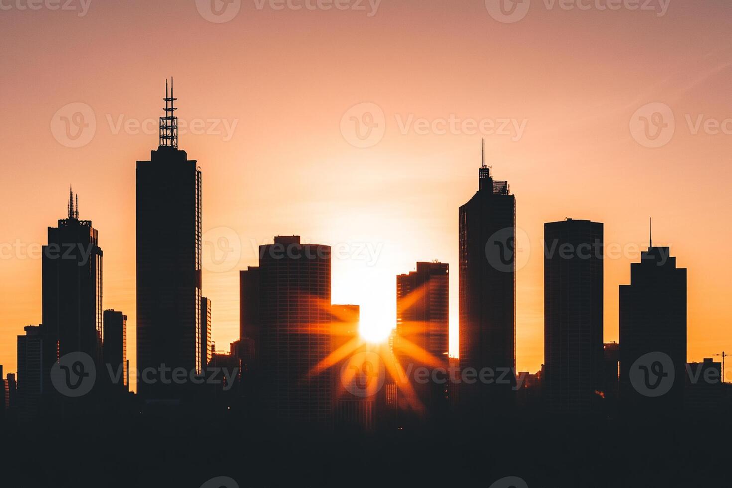 The sun is setting behind a city skyline photo
