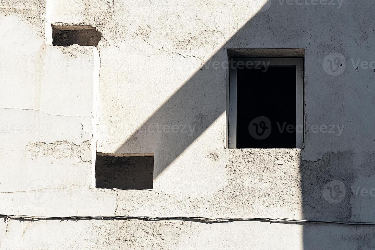 A white wall with a window and a street sign photo