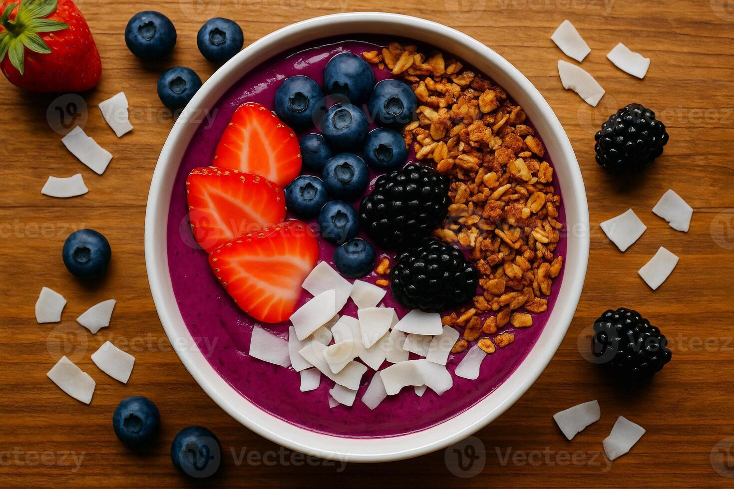 a bowl of blueberry smoothie with berries, coconut and berries photo