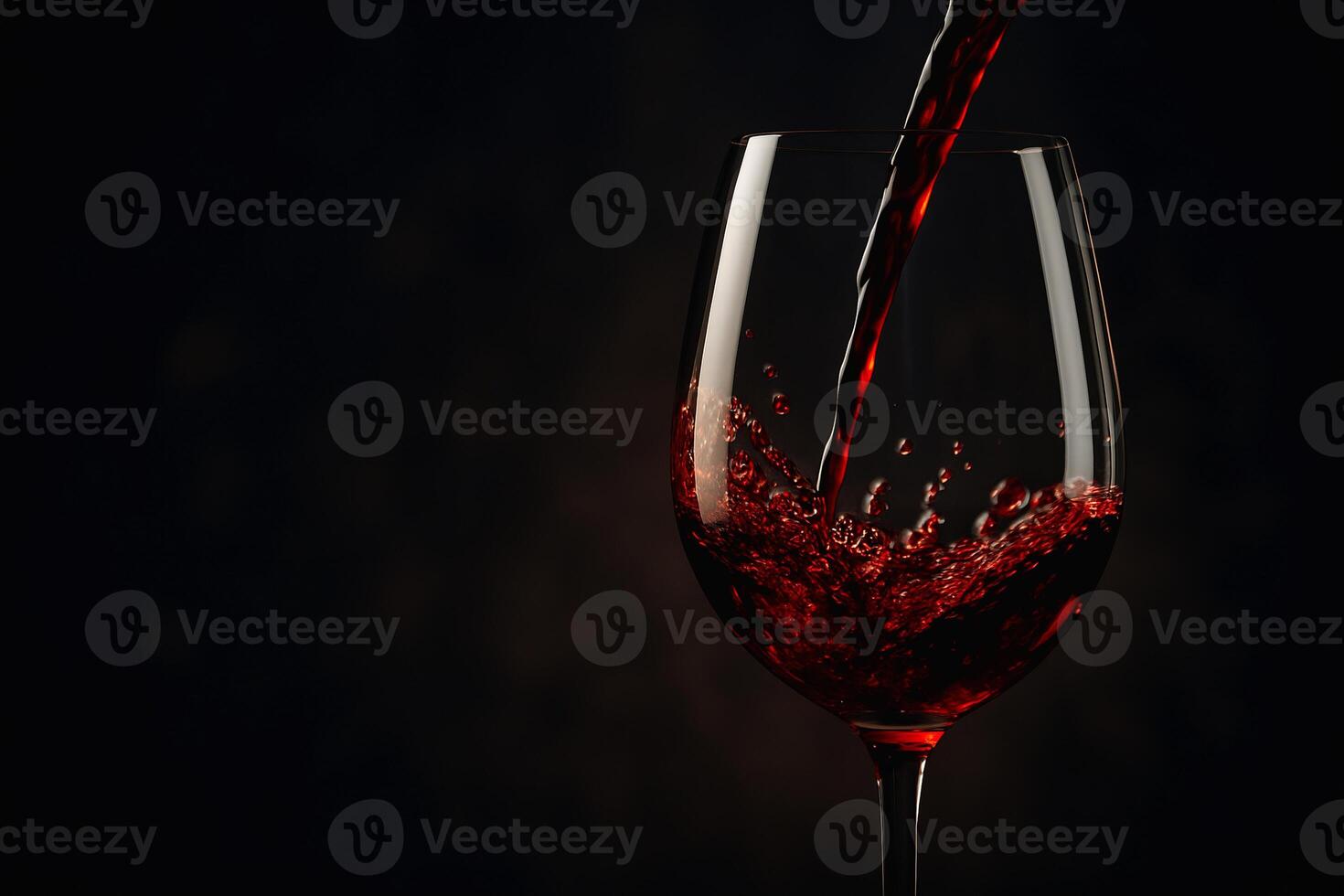 a wine glass filled with red wine photo