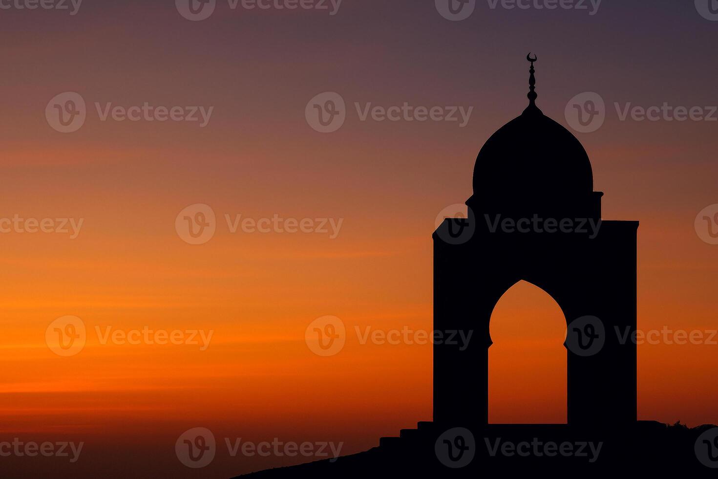 An awe-inspiring image capturing the silhouette of a mosque against the breathtaking backdrop of a vibrant sunset. photo
