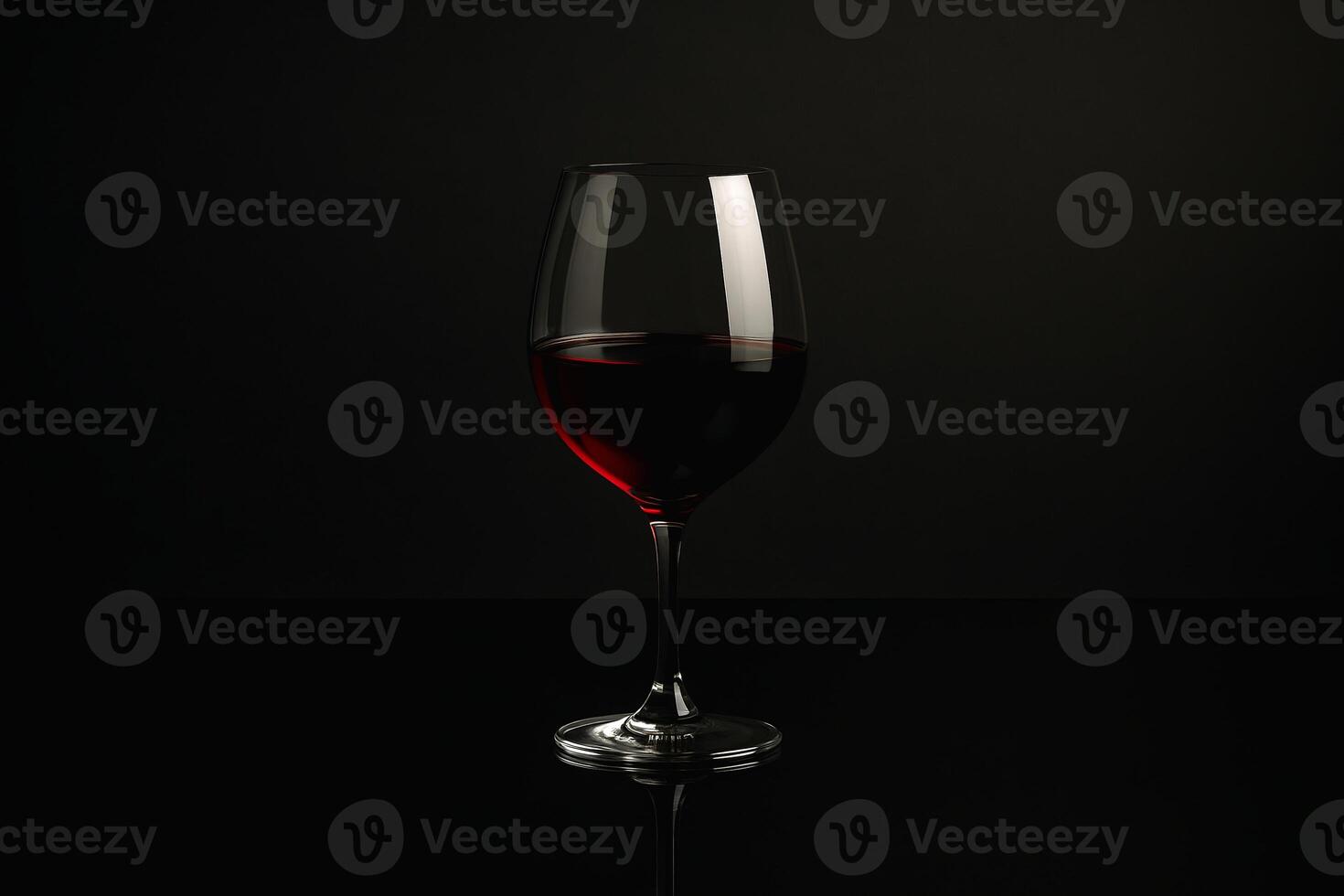 a glass of red wine on a black background photo