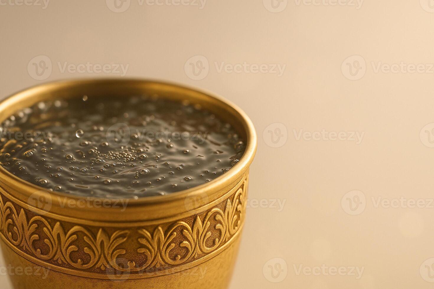 Traditional Brass Cup Filled with Water in Warm Light photo