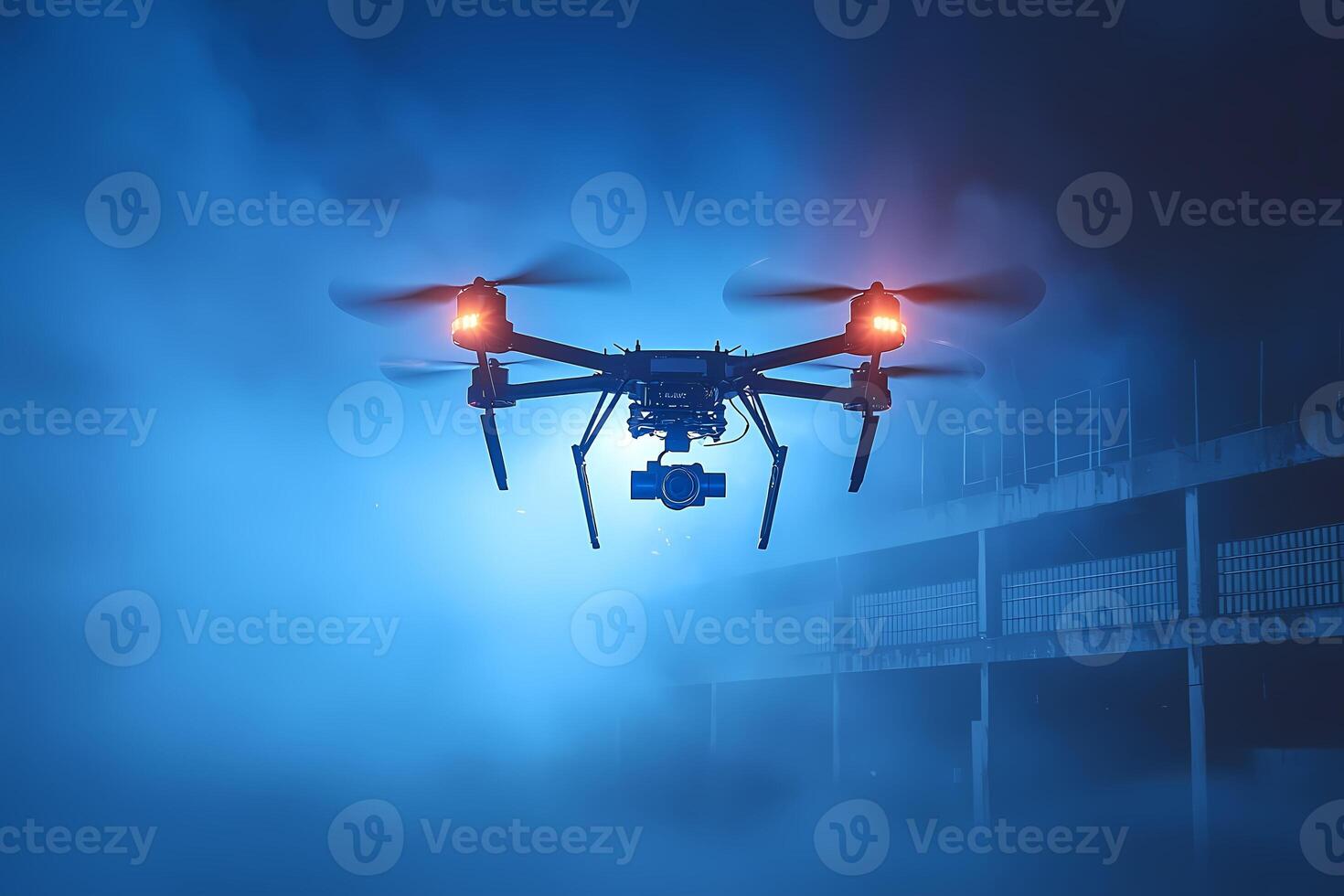 Drone flying at night recording an abandoned building with camera and flashing lights photo
