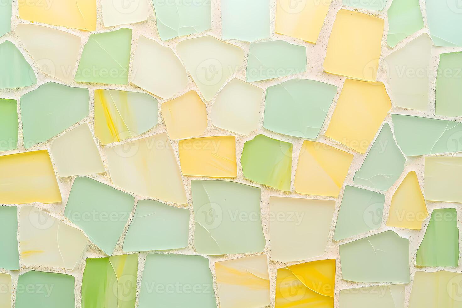 Irregular pastel yellow and green glass mosaic tiles creating textured surface photo