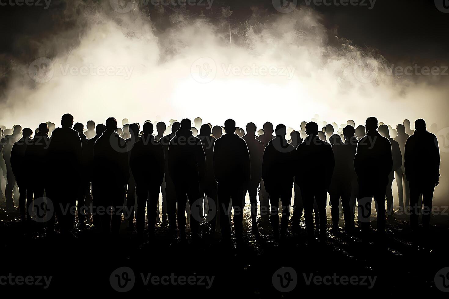 Crowd of people observing mysterious light in the fog at night photo