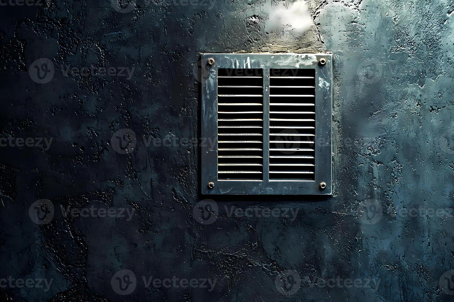 Metal grille providing ventilation on dark concrete wall photo