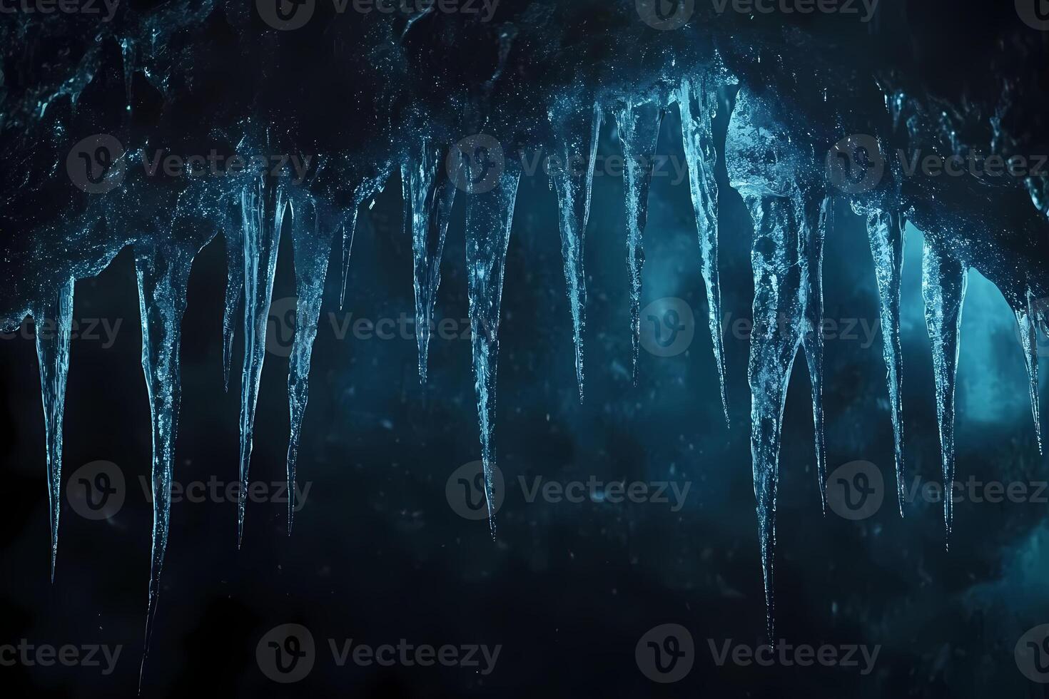 Sharp icicles hanging from ceiling of frozen cave in winter photo