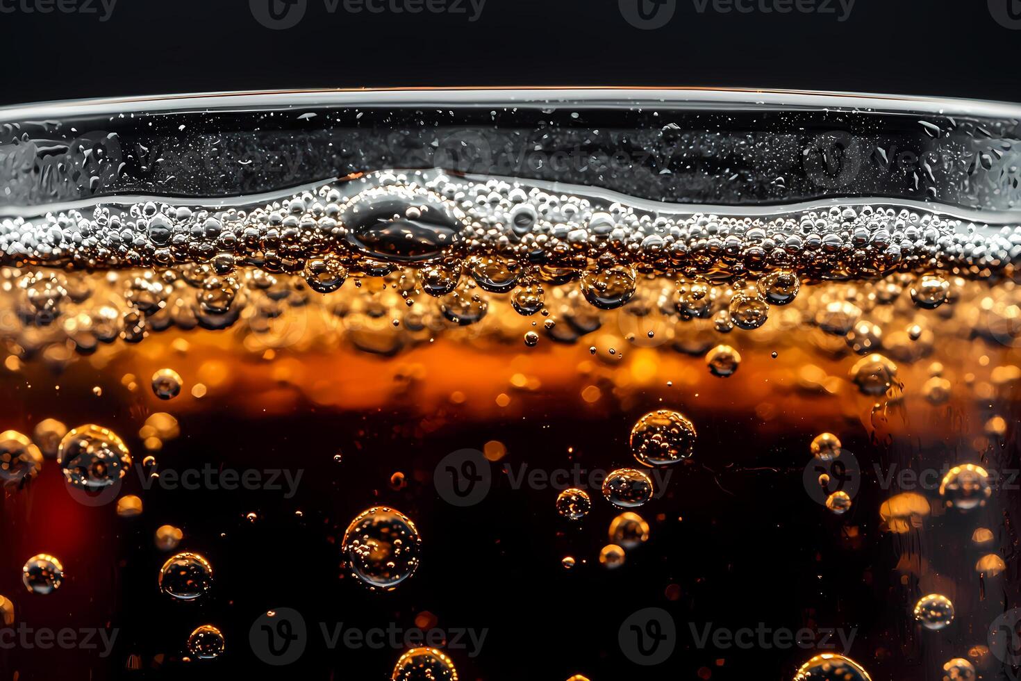 Glass with fizzy soda and ice cubes sparkling in golden light photo
