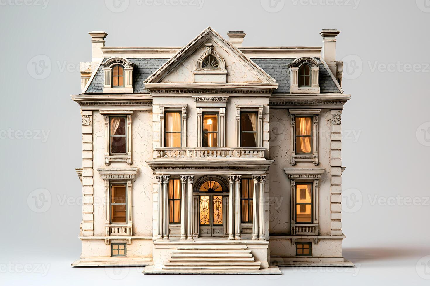 Miniature model of a luxurious victorian era mansion with illuminated windows photo