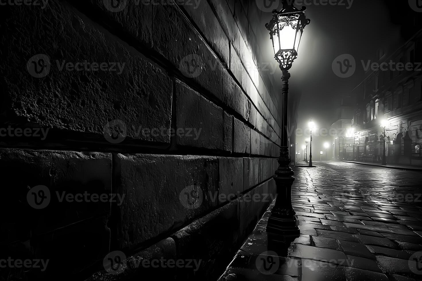 Foggy street at night with street lamps illuminating cobblestone road photo