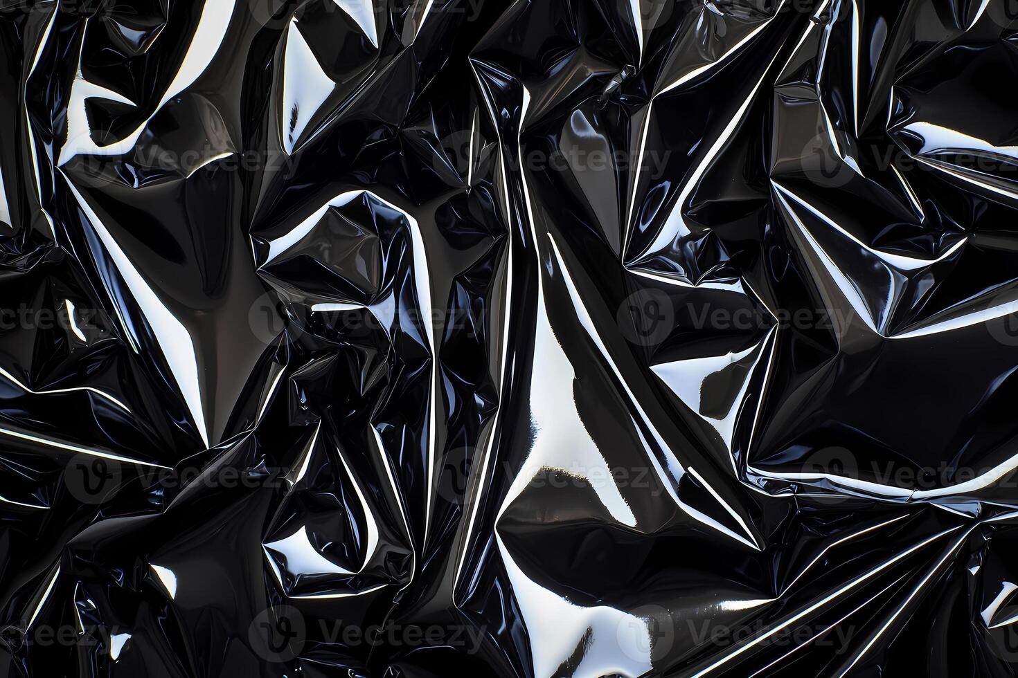 Shiny black plastic wrinkles creating abstract texture photo