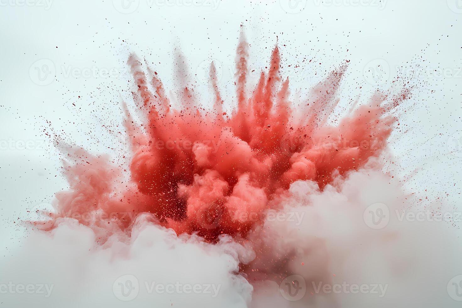 Red powder exploding creating a colorful cloud on white background photo