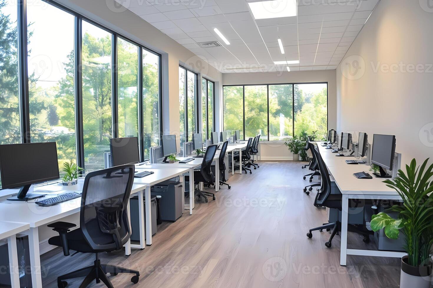 Modern open plan office with natural light and computers photo