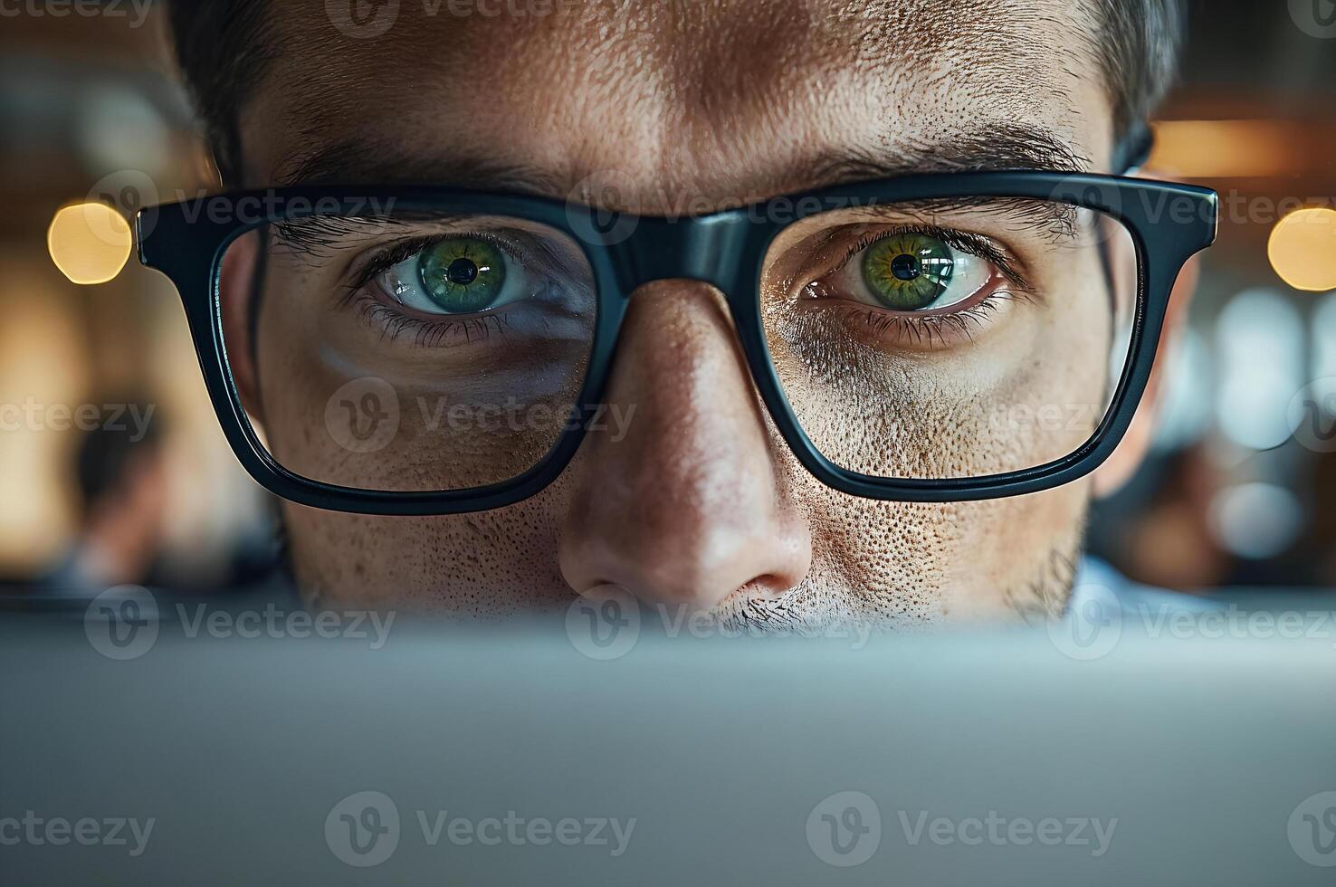 Focused businessman working late using laptop computer in dark office photo