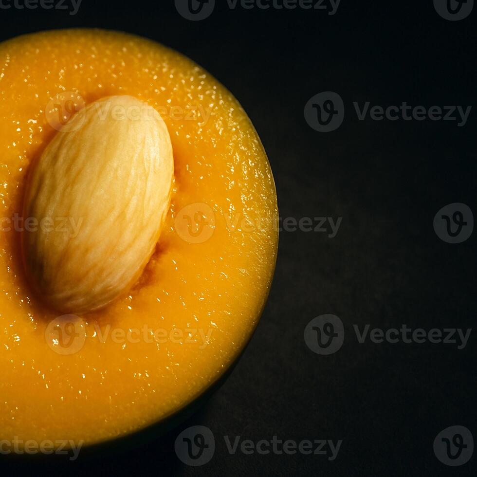a piece of fruit with a seed inside photo