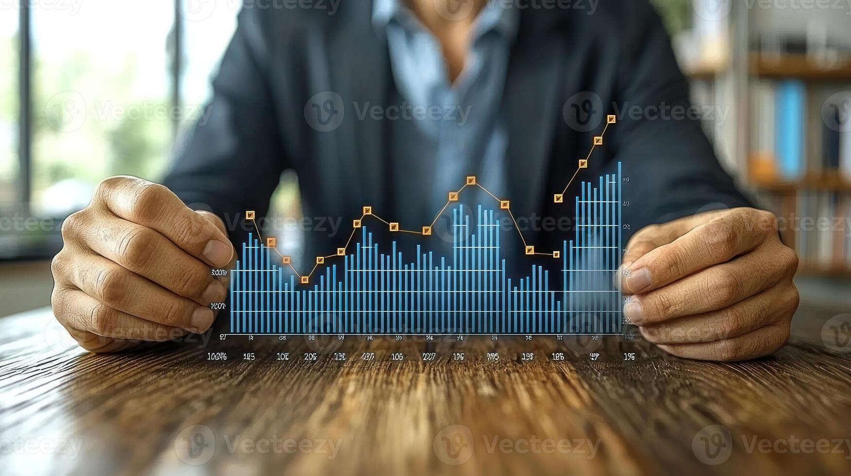A man in a suit is holding a graph on a table photo