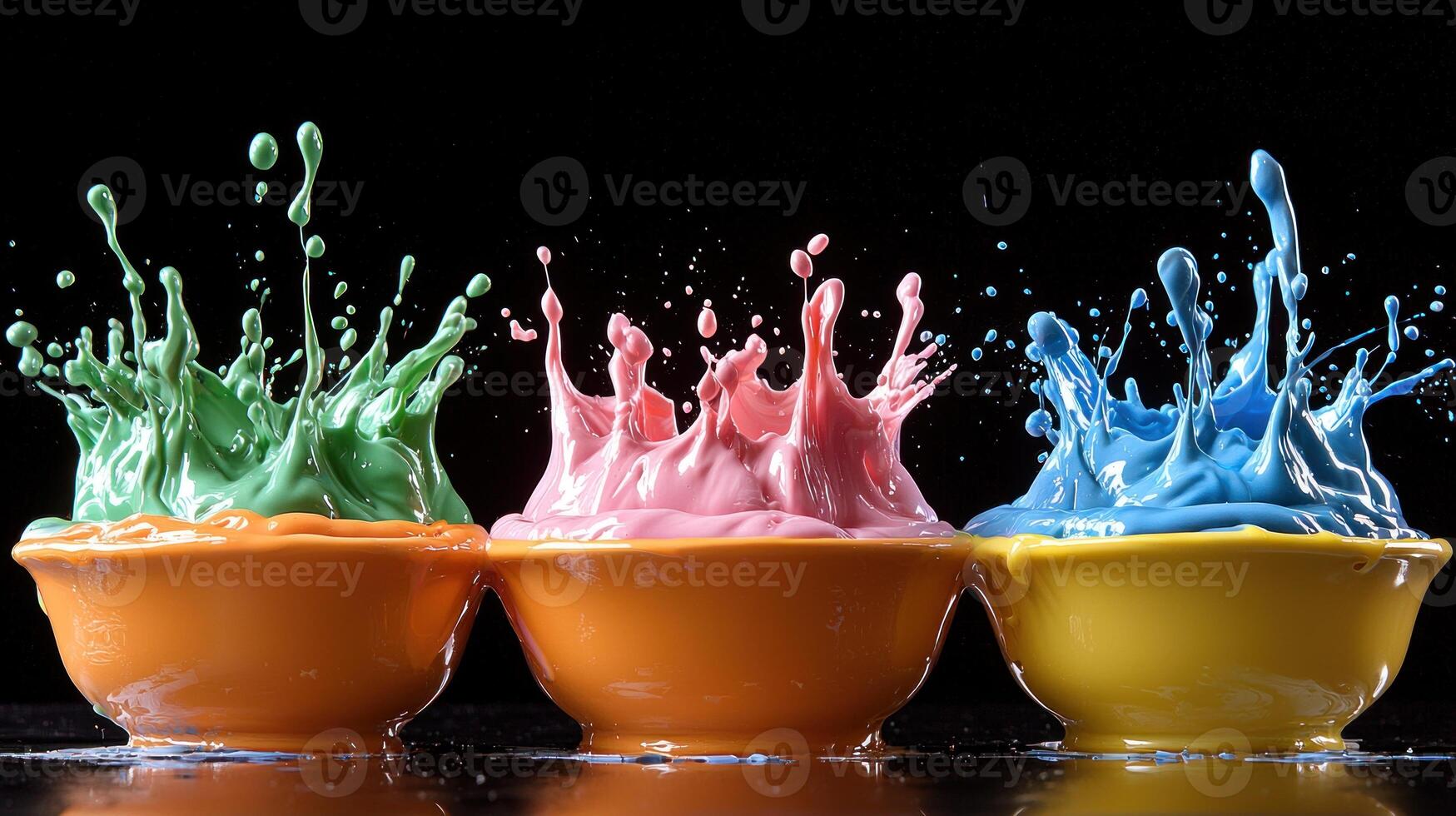 Three colorful cups with paint splashes photo