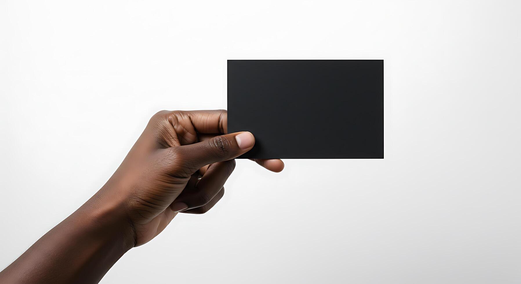 A person holding a black square card in their hand photo