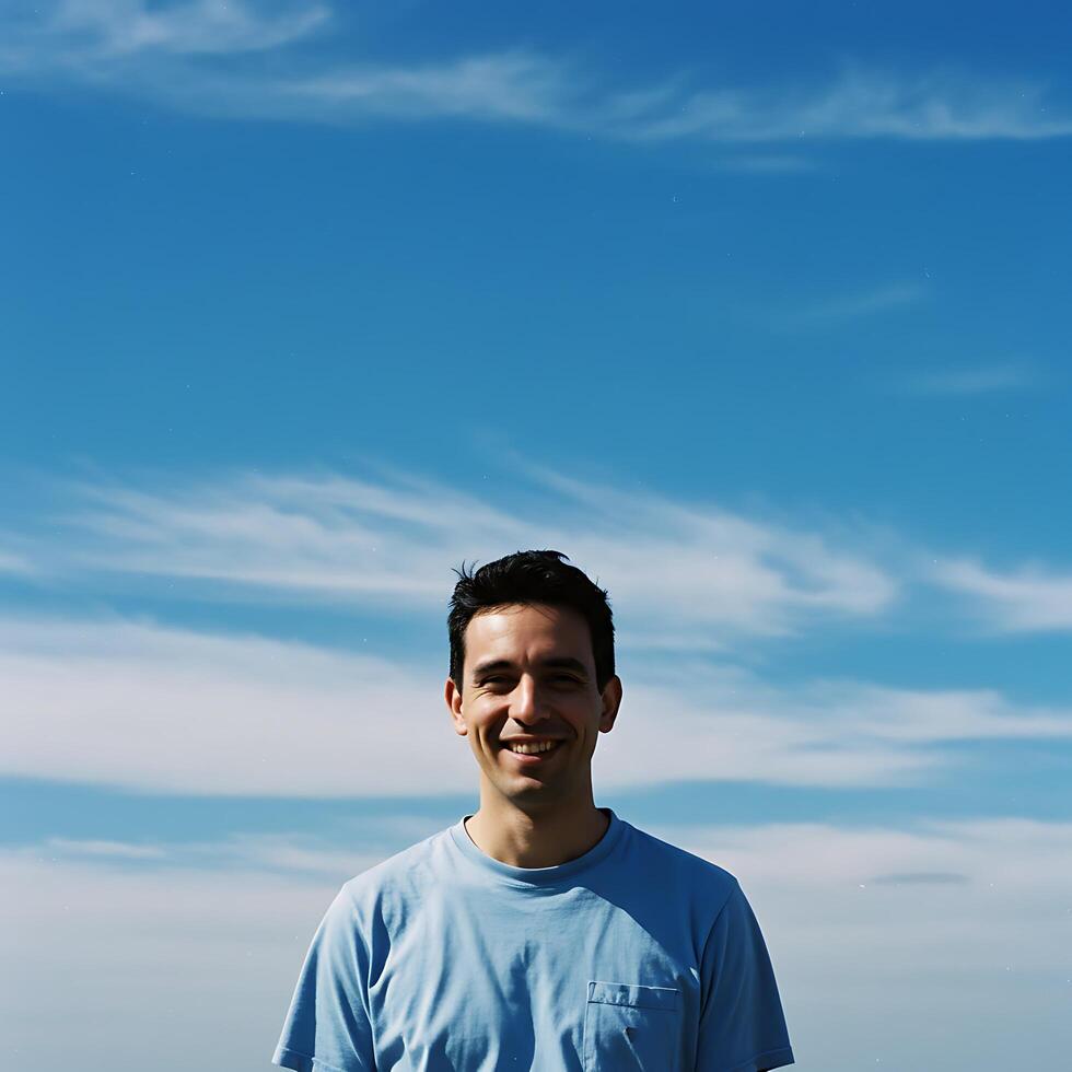 A man standing on a beach with a surfboard photo