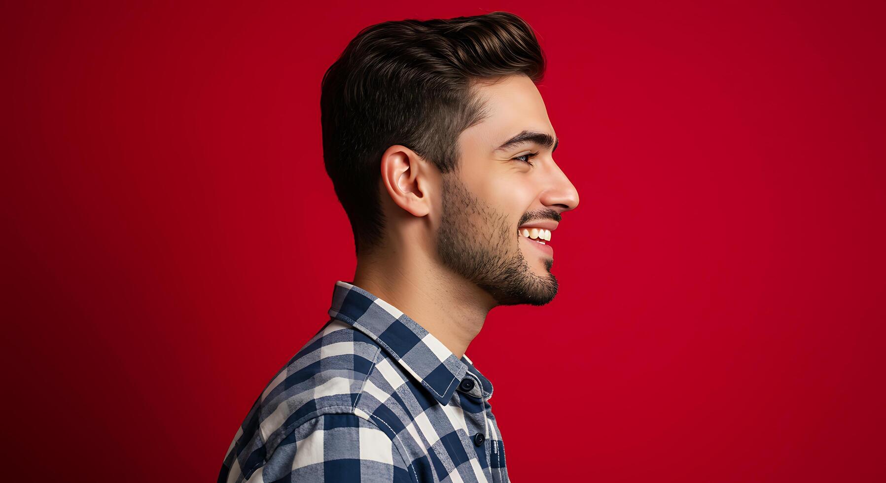 A man in a plaid shirt is smiling photo