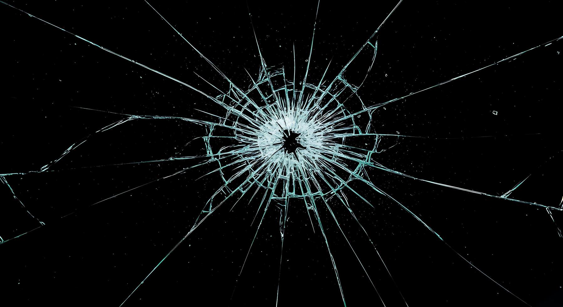 A broken glass window with a black background photo