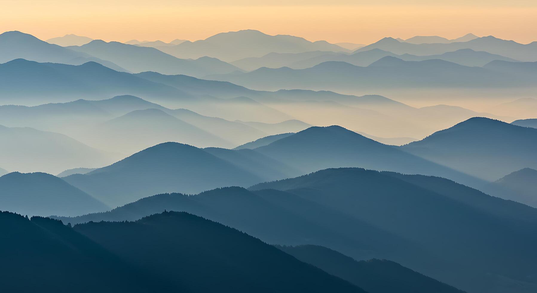 A mountain range with a blue sky photo