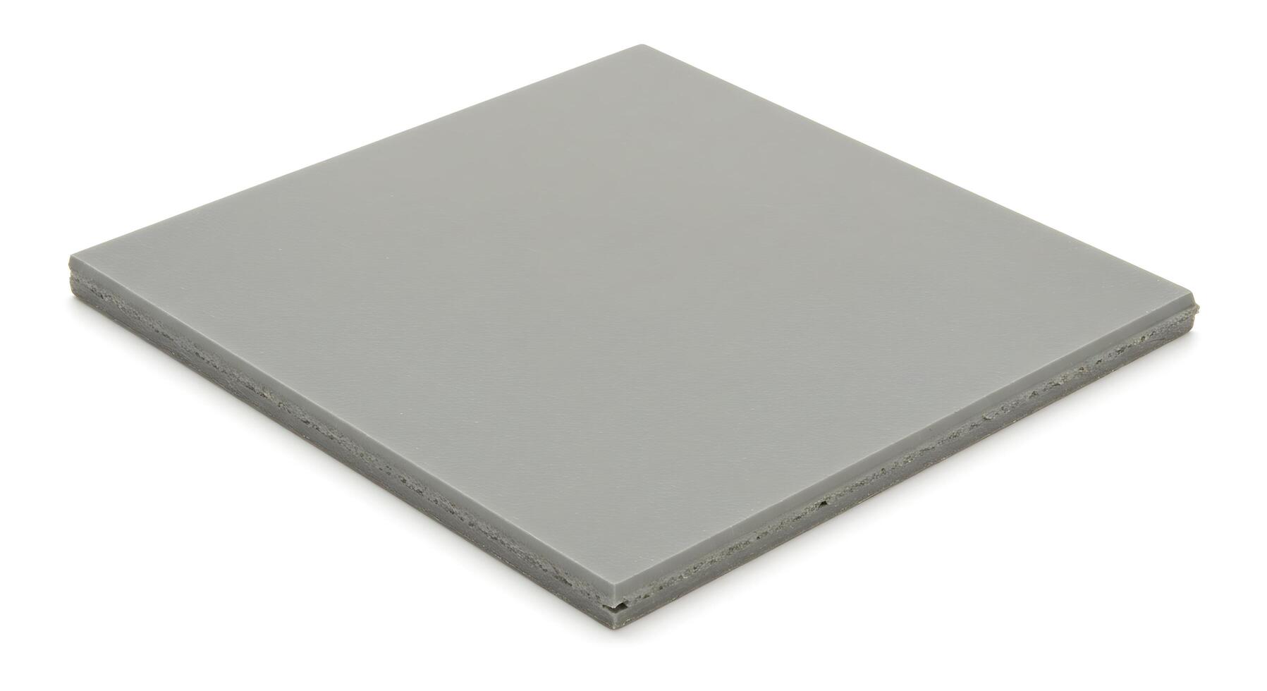 A gray square tile on a white surface photo