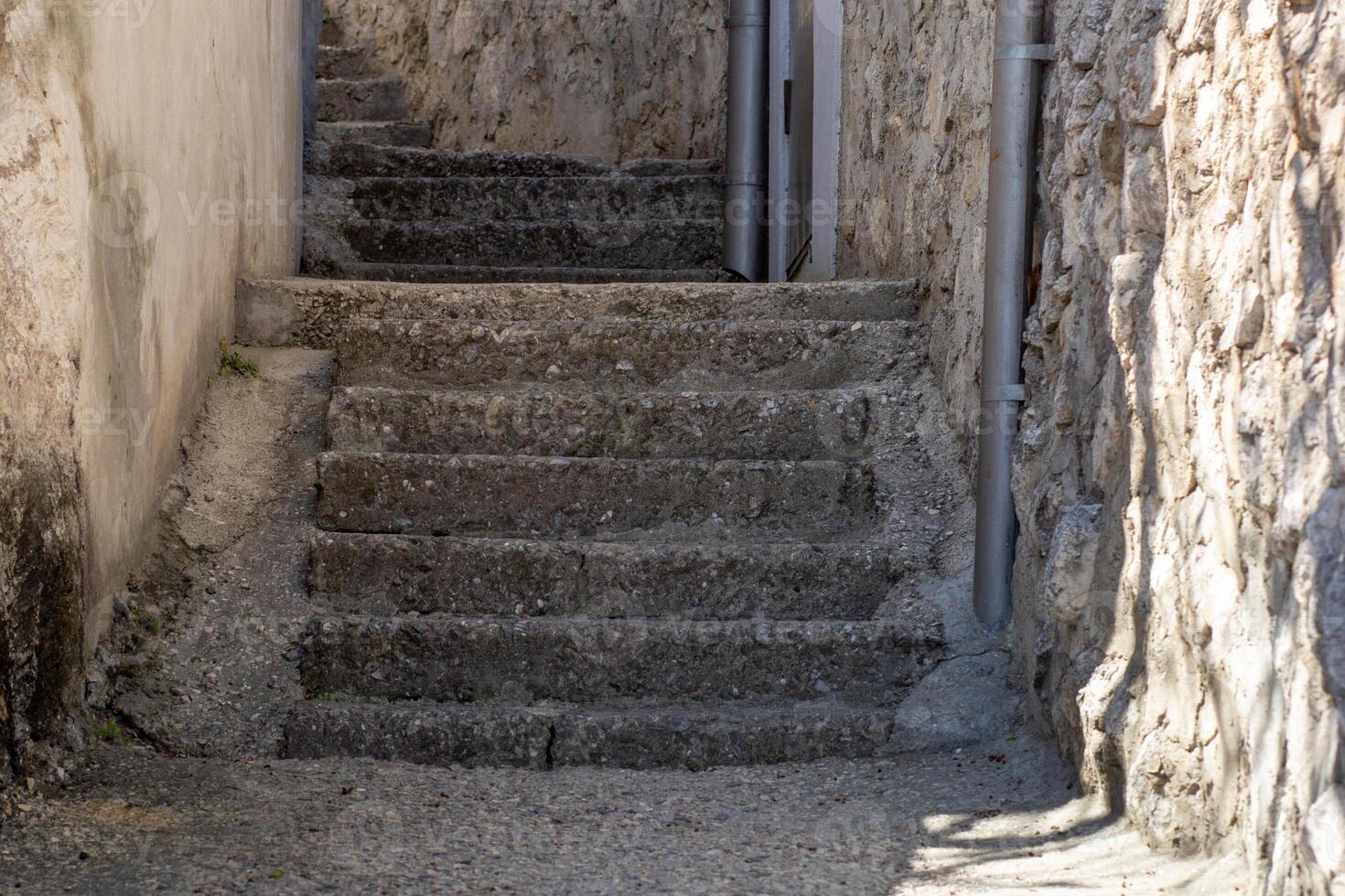 Ancient Stone Stairs Between Rustic Buildings photo