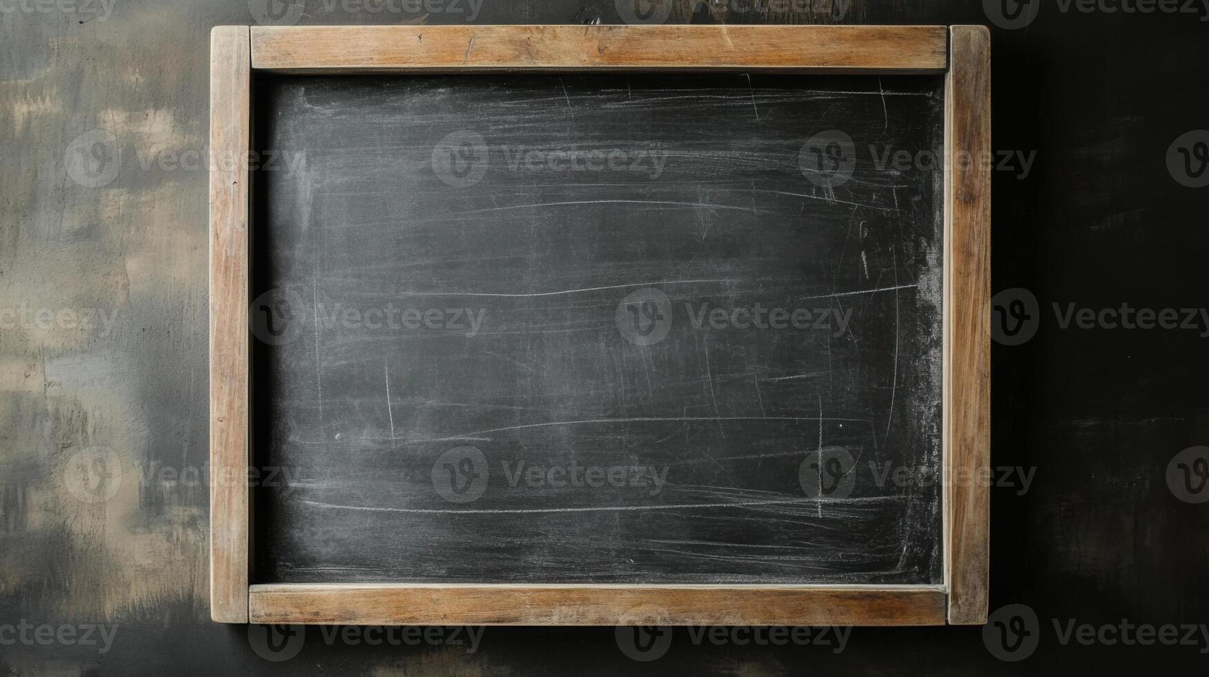 Empty chalkboard ready for lessons in a classroom setting during the day photo