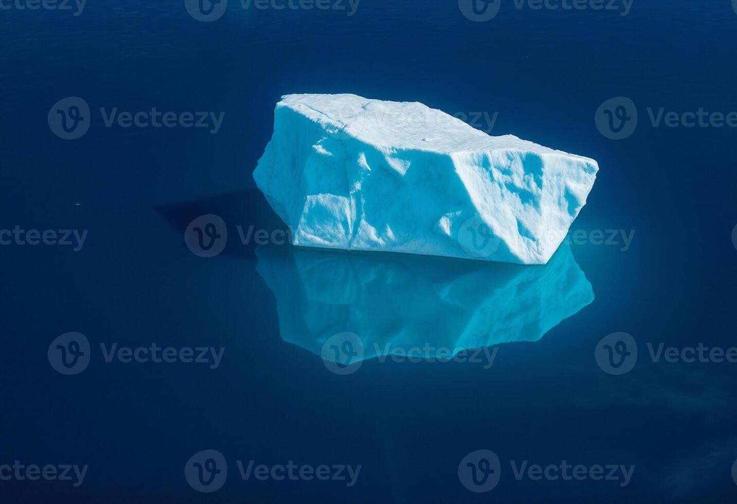 An iceberg floating in the ocean with a blue sky photo