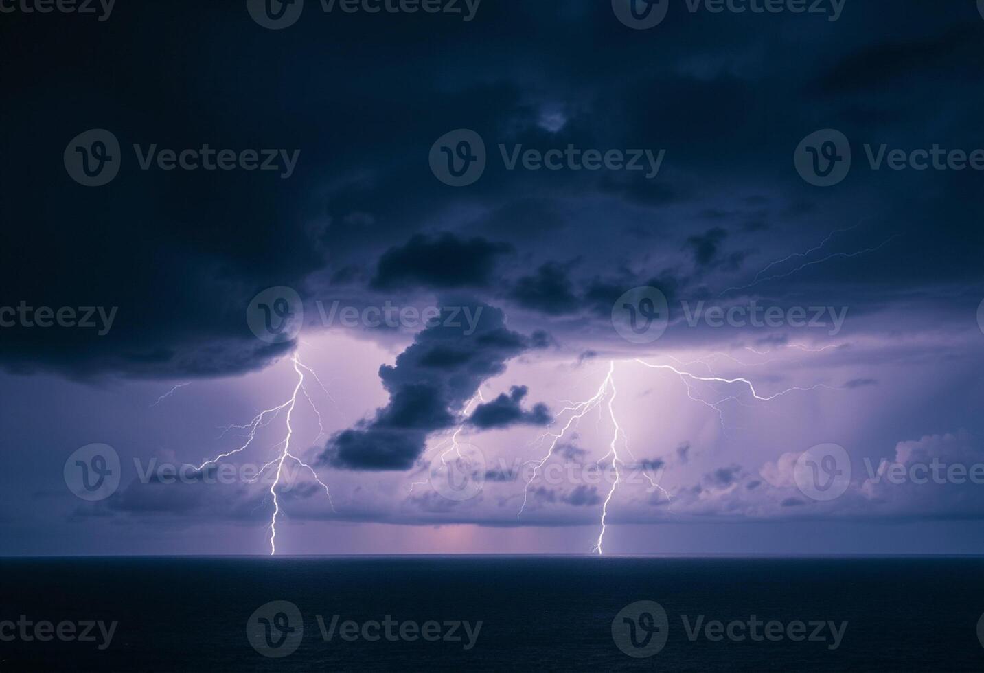 Lightning over the ocean with clouds and dark sky photo