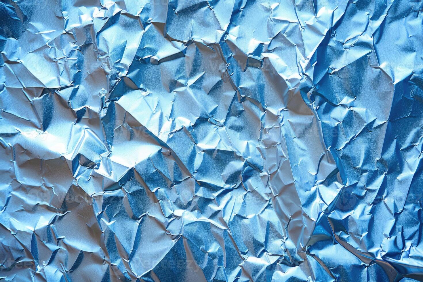 Close-up view of crumpled light blue foil. photo