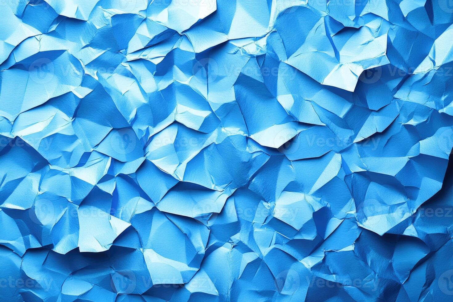 Close-up view of crumpled, vibrant blue paper texture. photo