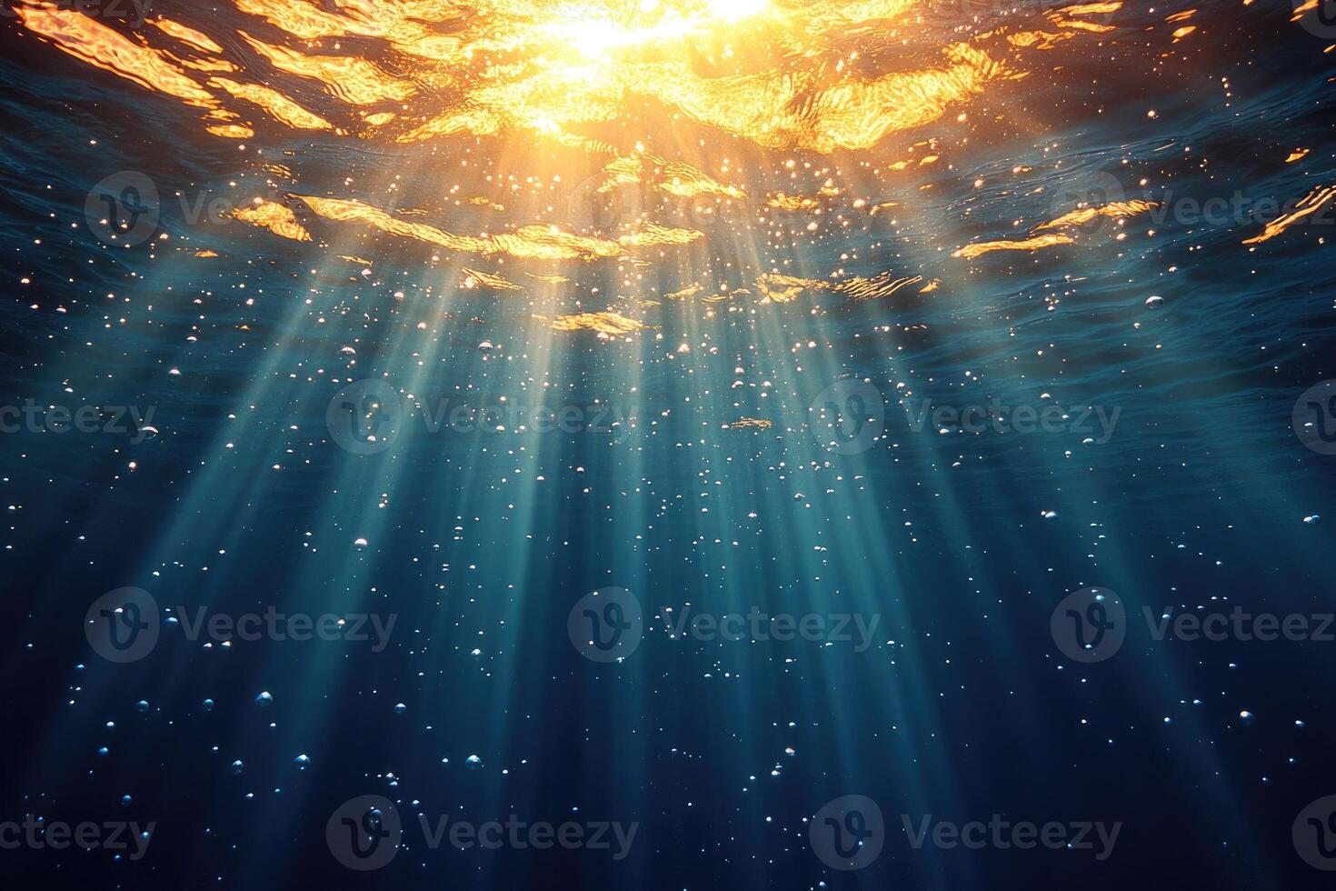 Sunlight beams through deep ocean water. photo