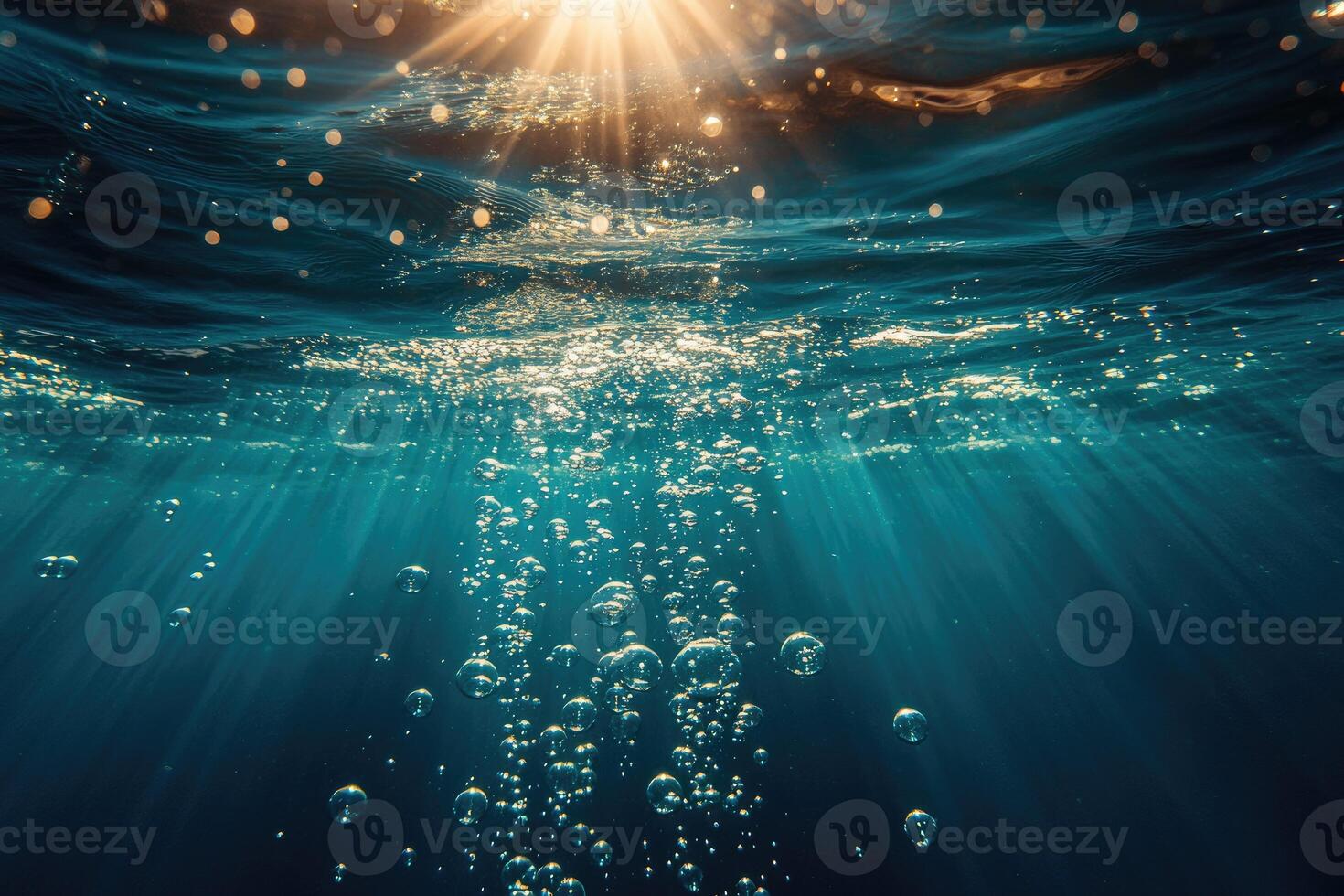 Subaquatic view of sunlight illuminating bubbles. photo