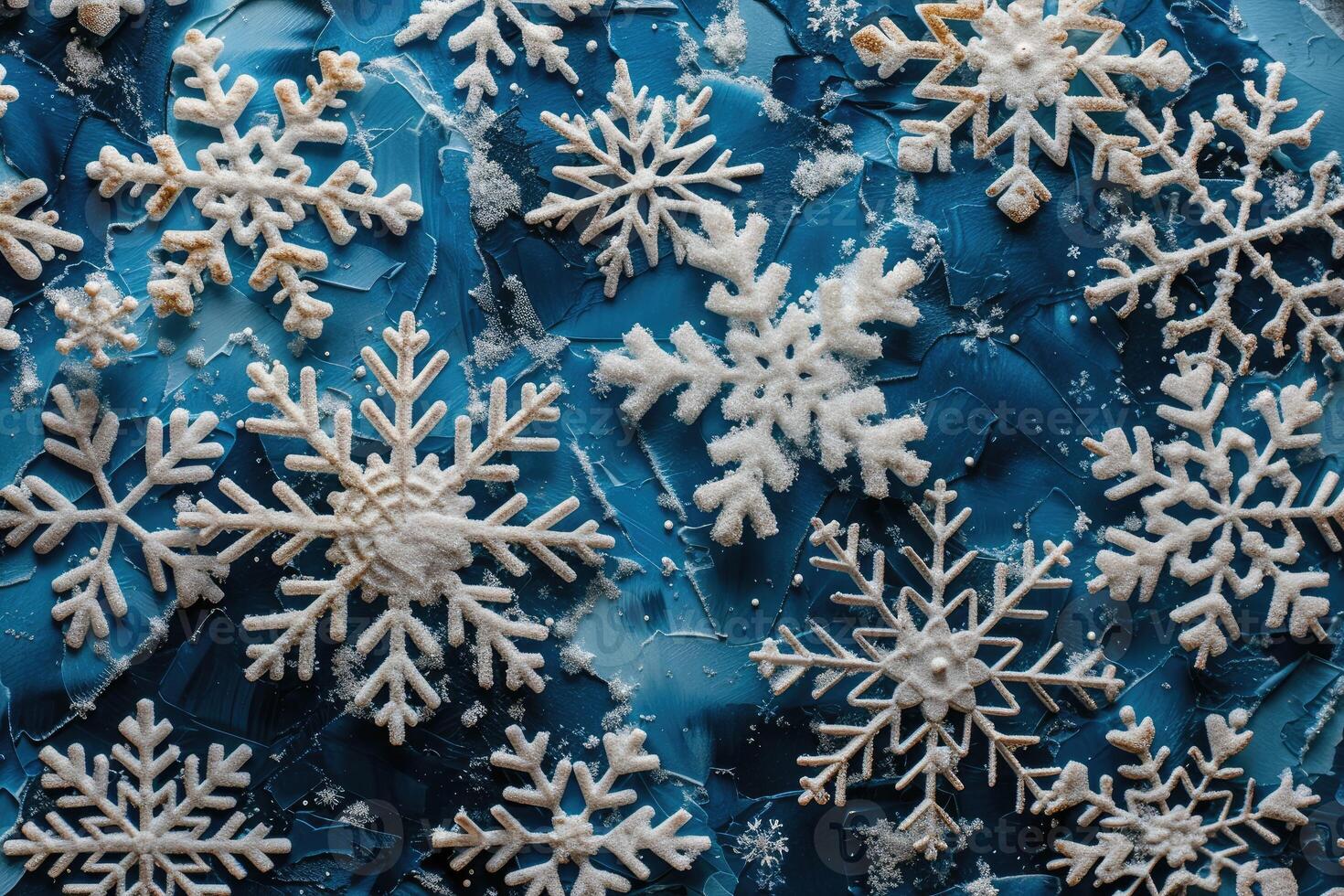 Festive snowflakes arranged on a textured blue surface. photo