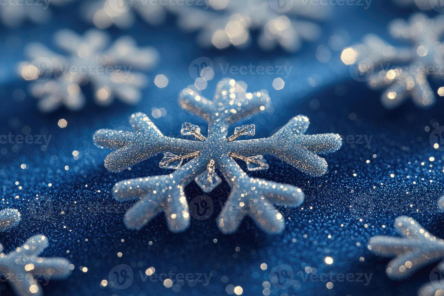Sparkling snowflake cluster on a dark blue surface. photo
