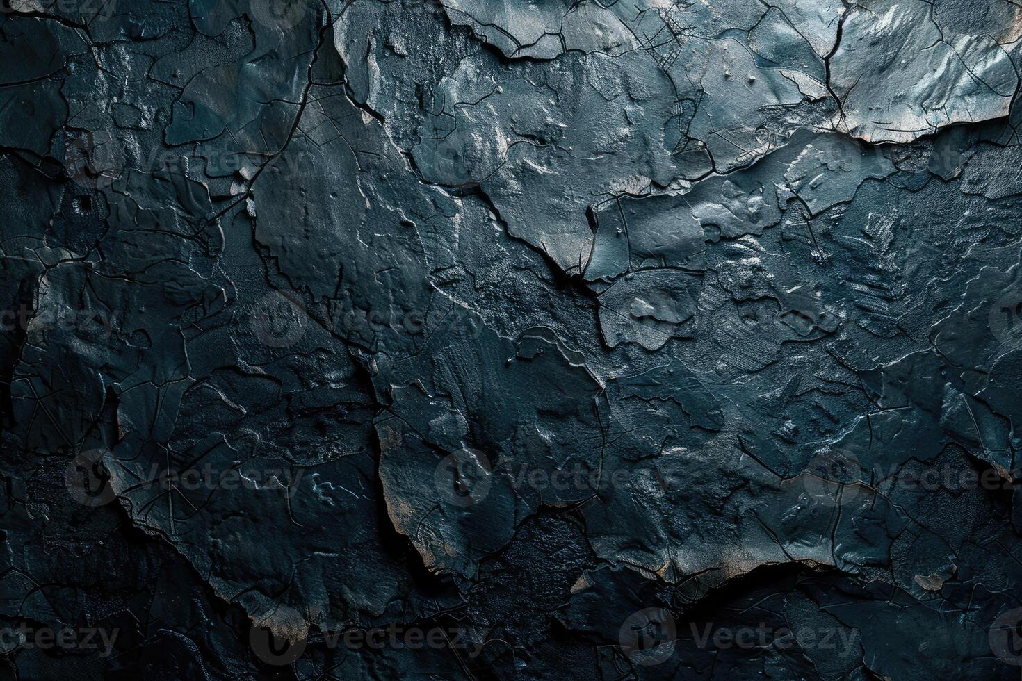 Close-up view of dark textured surface with deep cracks. photo