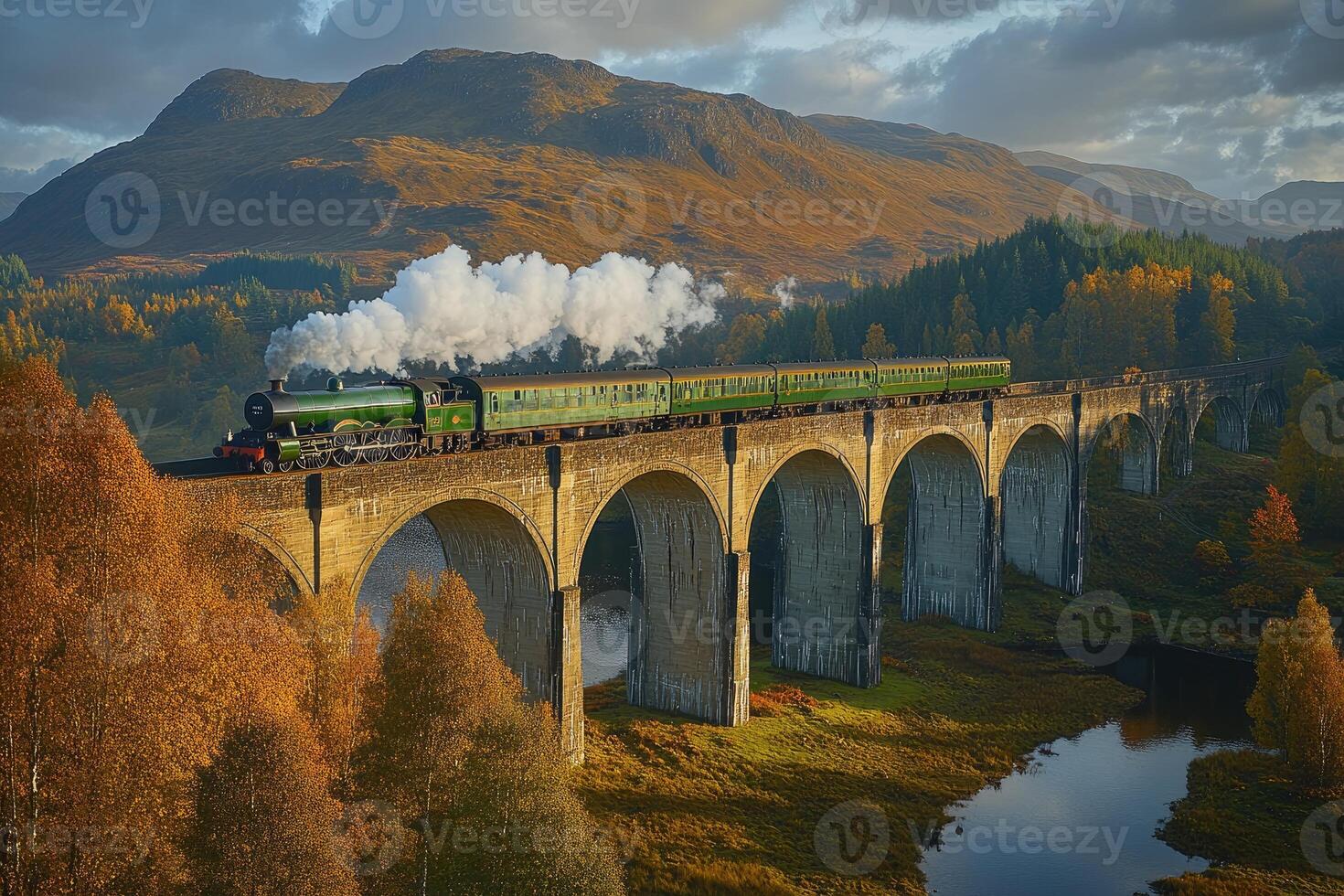 Majestic steam train crosses a mountain valley over an arching bridge. photo