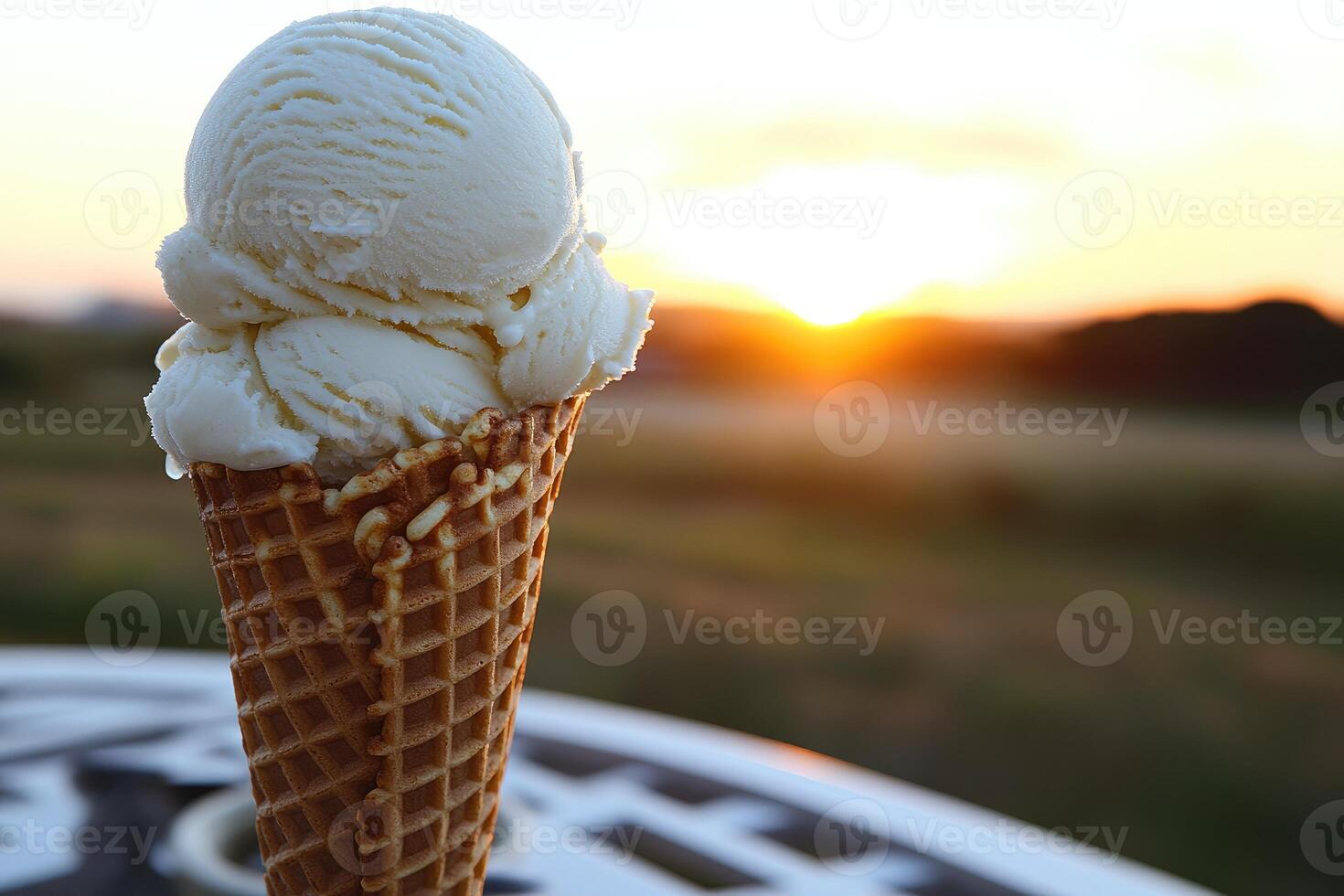 Creamy vanilla ice cream cone at sunset. photo