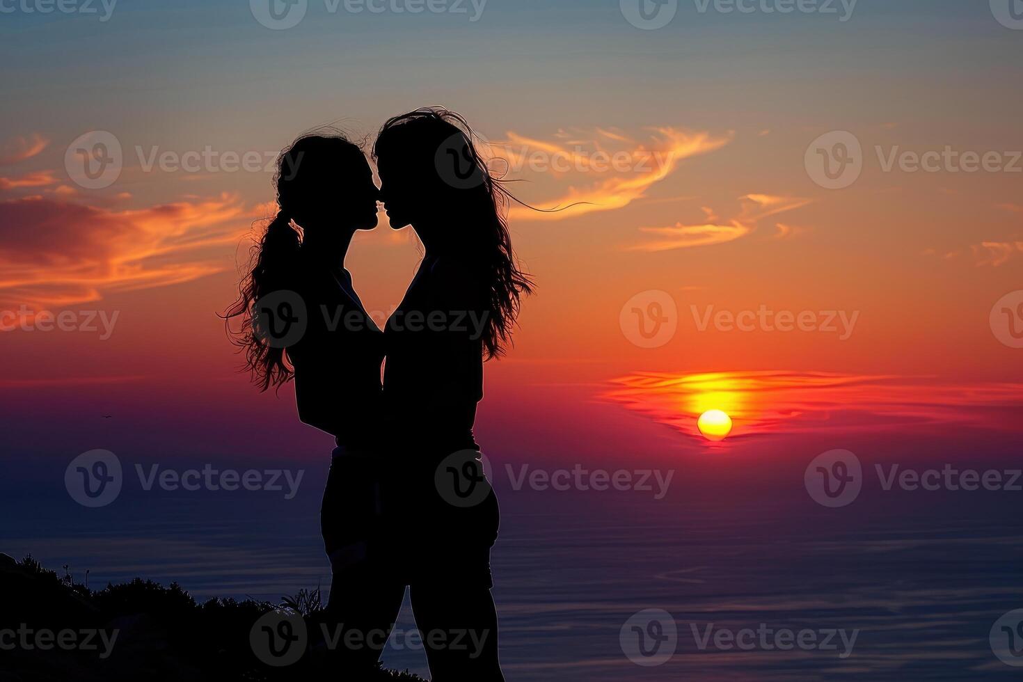 Two people embrace lovingly during a beautiful sunset photo