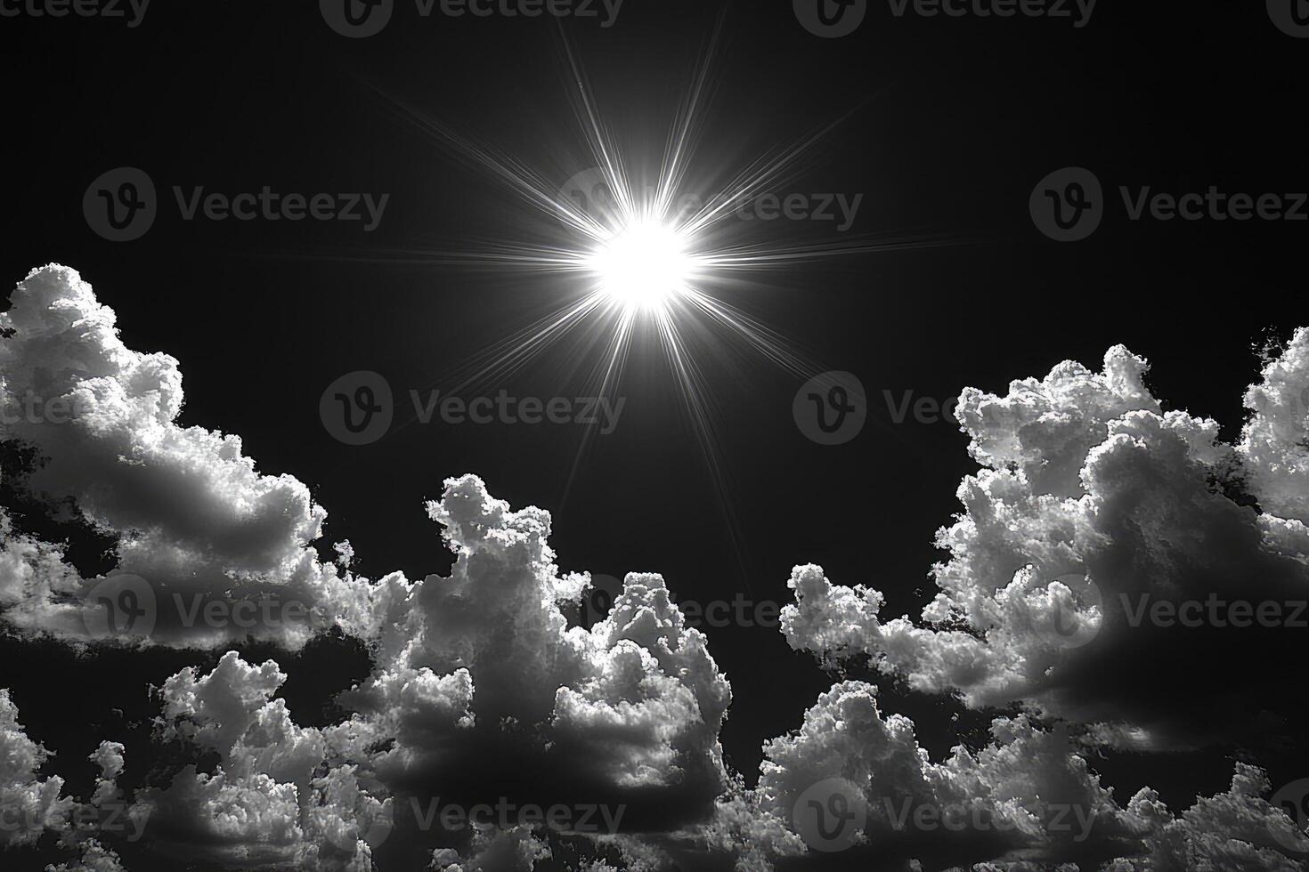 The brilliant sun shines brightly above fluffy white clouds in the sky photo