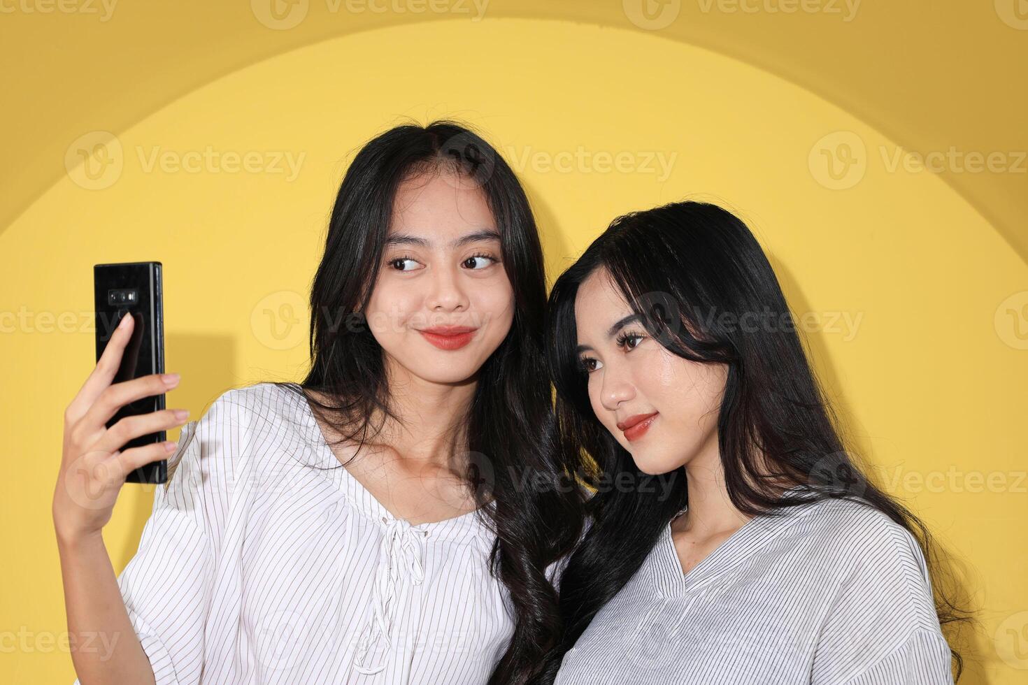 Two Generation Z Taking Selfie Together, Young Asian Bestie Girl Taking Photo using Mobile Phone.