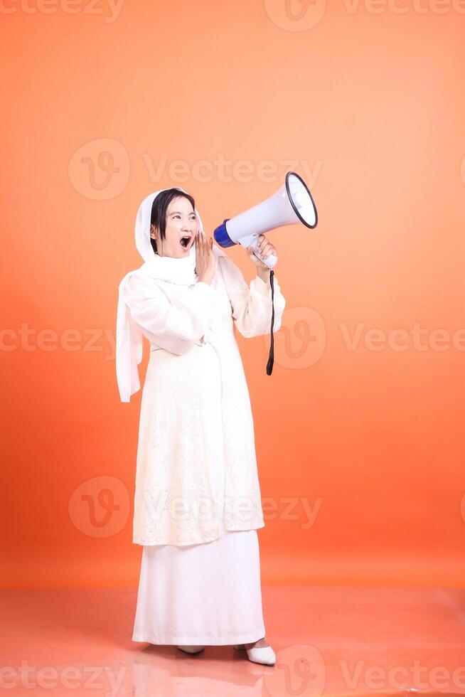 Empowered muslim lady using a megaphone to amplify her message, photo