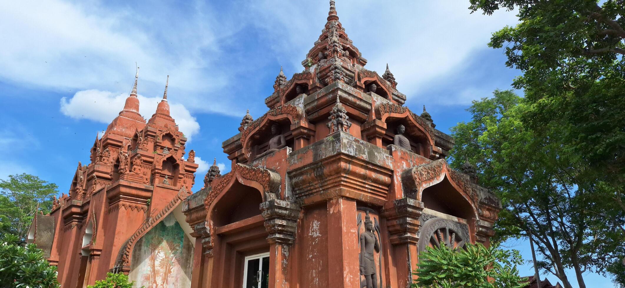 Wat Khao Angkhan -7 May 2025 The architecture of Wat Khao Angkhan with blue sky with clouds is located in Chaloem Phra Kiat District, Buriram Province, Thailand. photo