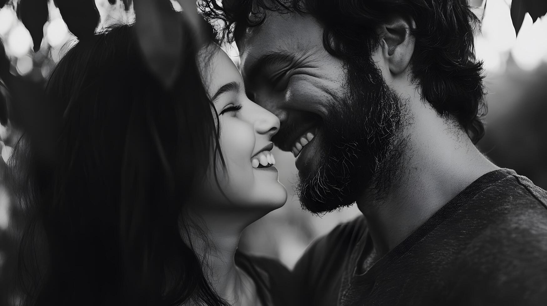 A man and woman are smiling together in front of a tree photo