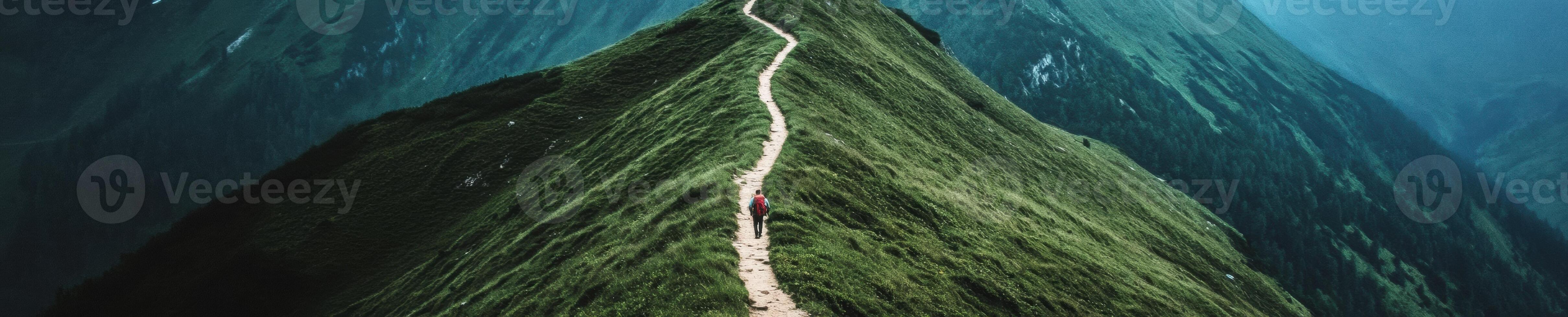 Aerial view of a serene winding trail through lush green mountains photo