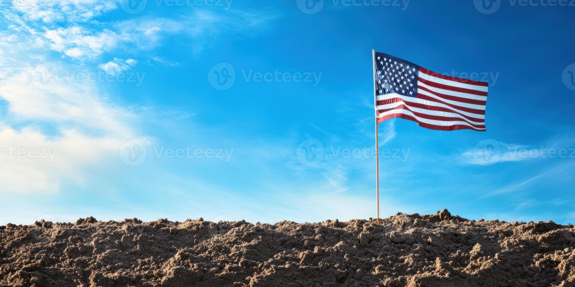 Majestic U.S. flag waving against a clear blue sky for patriotic celebration photo